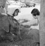 Photograph: [Photograph of Russ Bloxom petting a baby elephant]