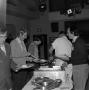 Photograph: [Photograph of individuals serving themselves food at an event]