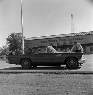 Primary view of object titled '[Ward Andrews cleaning a T-Bird]'.