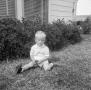Photograph: [Photograph of Curt Stiles Jr sitting in the grass]