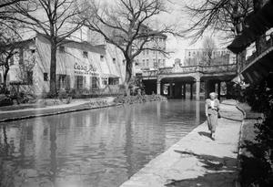 Primary view of object titled '[Photograph of a woman walking down the San Antonio River Walk]'.