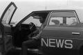 Photograph: [KXAS employee sitting in a news automobile, 2]