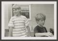 Photograph: [Photograph of Dustin and Derrick in front of a house]