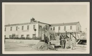 Primary view of object titled '[Man constructing a stone building in front of the Stevenson House in Monterey, California]'.