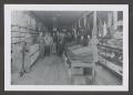 Photograph: [Photograph of individuals posing inside a clothing store]