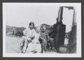 Photograph: [Photograph of a woman and two children posing outside]