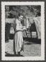 Photograph: [Photograph of Doris Stiles Williams posing by a clothesline]