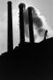 Photograph: [Silhouette of factory smokestacks]