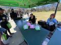 Photograph: [Baseball cap decorating table outside the UNT Union during UnionFest]