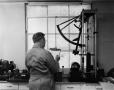 Photograph: [Ennis, Man with an Electro-Hydraulic Tensile Tester]