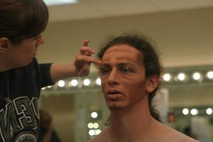 Primary view of object titled '[Person applying stage makeup to actor]'.