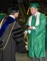 Photograph: [Zachary Catt receiving his diploma during commencement]