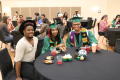 Photograph: [2017 graduates and a guest at their table]