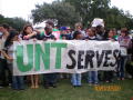 Photograph: [People holding UNT SERVES banner]