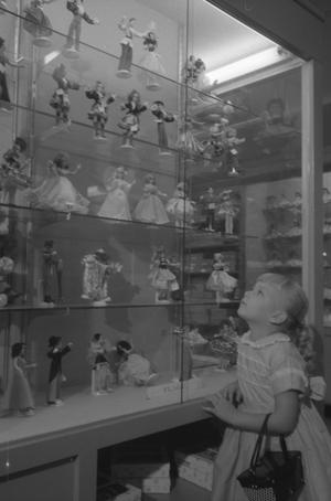 Primary view of object titled '[Cheryl looking up at a display of toys, 3]'.