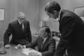 Photograph: [John DeLorean, Ed Cole and another man in an office, 2]