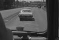 Photograph: [An automobile driving down a street]