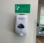 Photograph: [Hand sanitizer dispenser and signage in the UNT Union]