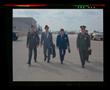 Photograph: [Officials and pilots walking on the Bell helipad]