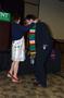 Photograph: [Student in suit and serape stole, MC ceremony 1]