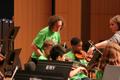 Primary view of [Instructors helping students learn violin at the UNT Music Summer Orchestra Day Camp]
