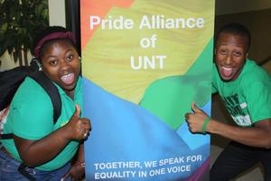 Primary view of object titled '[Students on either side of Pride Alliance sign]'.