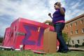Photograph: [Woman builds sorority-themed house at Shack-a-thon fundraising event]