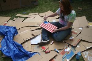 Primary view of object titled '[Woman paints American flag during Shack-a-thon fundraising event]'.