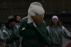 Primary view of object titled '[Scrappy the Eagle standing with North Texas Dancers during a UNT football game]'.