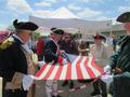 Photograph: [David Kinsey cuts flag at Flag Retirement Ceremony]