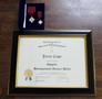 Photograph: [Distinguished Service Medal and framed certificate for Jerry Cope]
