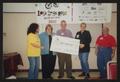 Photograph: [Members holding the final check: Lone Star Ride 2002 event photo]