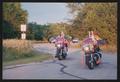 Primary view of [Caravan lead by two heavily decorated motorcycles: Lone Star Ride 2004 event photo]
