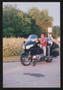 Photograph: [Couple riding by on a motorcycle: Lone Star Ride 2004 event photo]