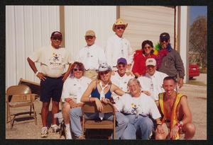 Primary view of object titled '[Pit stop group smiling into direct sun: Lone Star Ride 2001 event photo]'.