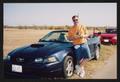 Photograph: [Crew member and their Ford Mustang: Lone Star Ride 2005 event photo]