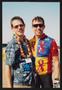 Photograph: [A cyclist and a crew member in a Hawaiian shirt embracing: Lone Star…