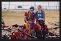 Photograph: [Five cyclists posed by a tennis court: Lone Star Ride 2005 event pho…