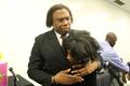 Photograph: [Curtis King hugs student 1 at Congo Street awards ceremony]