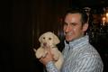 Photograph: [Man 1 holds auction puppy at 2005 Black Tie Dinner]