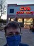Photograph: [Robert Moore in front of a CVS Pharmacy entrance]