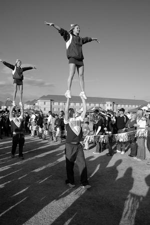 Primary view of object titled '[UNT cheerleaders perform at 2005 Homecoming Parade]'.