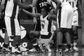 Photograph: [Teammates help Kennethia Wilson stand up]