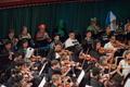 Primary view of [Close-up of violinists and brass instrument musicians performing at the Spooktacular Performance]
