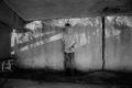 Photograph: [Young Derrick Williams standing against a wall]