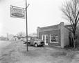 Photograph: [The Trussel Garage with a pickup truck parked out front]