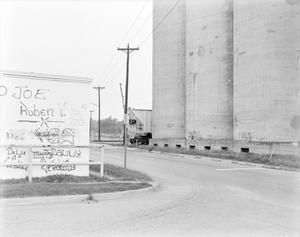 Primary view of object titled '[A grain elevator and a graffiti wall]'.