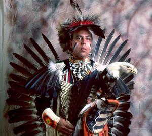 Primary view of object titled '[An Indigenous American in traditional black and red powwow clothing, 2]'.