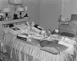 Primary view of object titled '[Bed filled with wedding gifts]'.