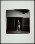 Photograph: [Young man standing in a doorway]